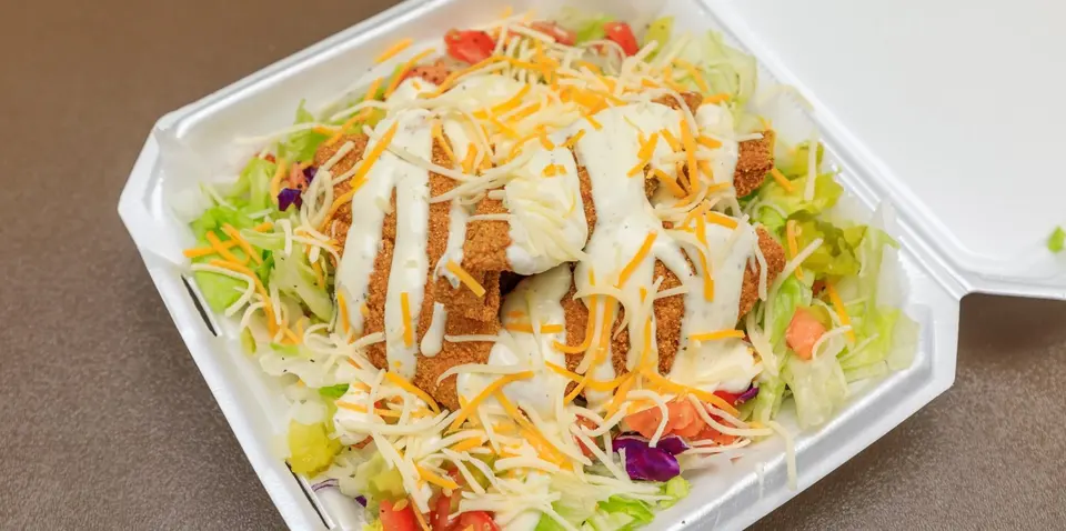 Loaded salad topped with crispy chicken